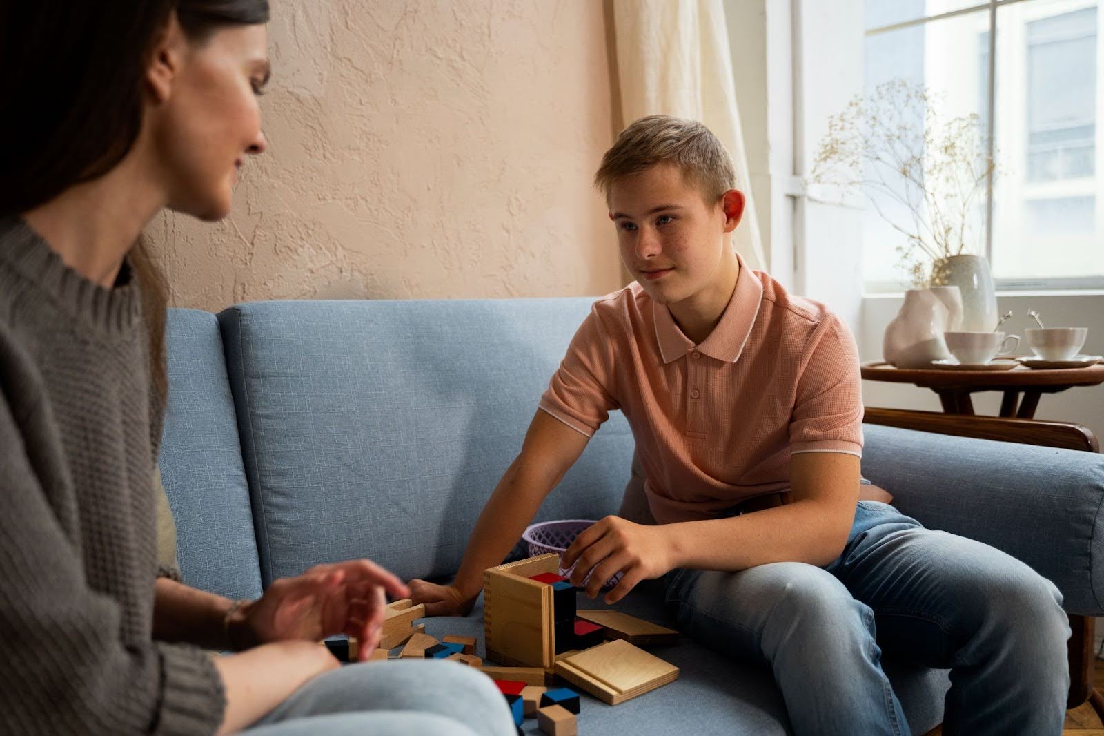 youn man with autism sits with caregiver autistic masking eccm