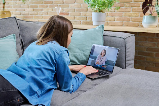 young woman uses laptop to speak with supports coordinator eccm manaegd care in pennsylvania